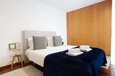 a bedroom with a large bed with towels on it at Enjoy Apartments Maria in Barcelona