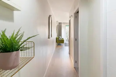 a hallway with white walls and a potted plant at Tendency Apartments Forum 4 in Sant Adria de Besos