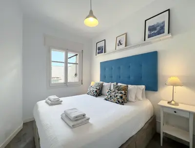 a bedroom with a large bed with a blue headboard at Stay U-nique Apartments Legalitat in Barcelona