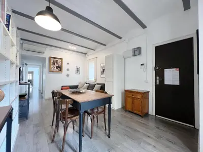a kitchen and dining room with a table and chairs at Stay U-nique Apartments Legalitat in Barcelona