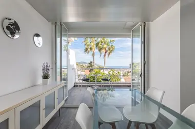 a glass dining room with a view of the ocean at Miramar Sitges in Sitges