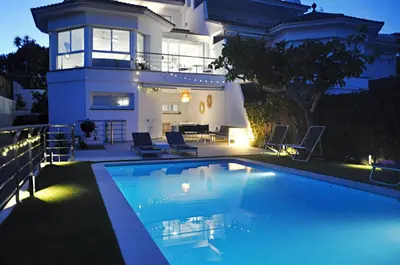 a large swimming pool in front of a house at Miramar Sitges in Sitges