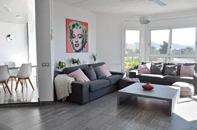 a living room with a couch and a table at Miramar Sitges in Sitges