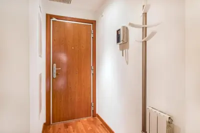 a wooden door in a room with a cross on the wall at Stay U-nique Apartments Plaça de Tetuan in Barcelona
