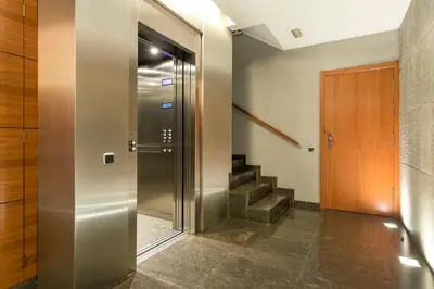 a hallway with a elevator and a staircase at Stay U-nique Apartments Plaça de Tetuan in Barcelona
