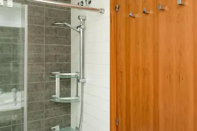 a shower with a wooden door in a bathroom at Stay U-nique Apartments Plaça de Tetuan in Barcelona
