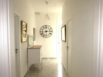 a hallway with a clock on the wall at Pensió Cerdanya in Barcelona