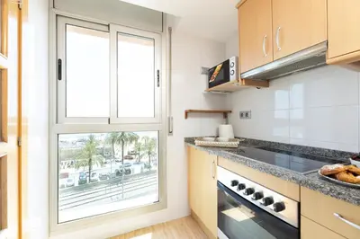 a kitchen with a large window and a counter at matarolux17 in Mataró