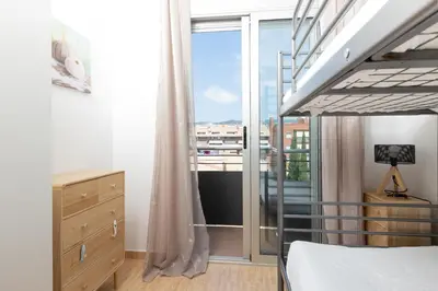 a bedroom with a bed and a large window at matarolux17 in Mataró