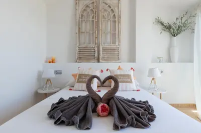 a bed with two swans made out of towels at matarolux17 in Mataró
