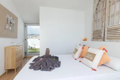a bedroom with a bed with two stuffed animals on it at matarolux17 in Mataró