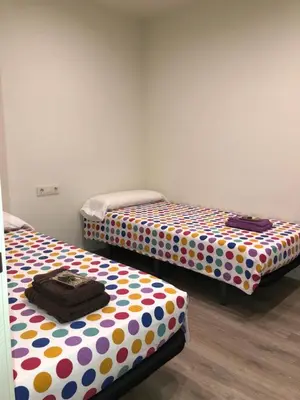 two beds with polka dot sheets in a room at Calella Playa Vistas Mar in Calella