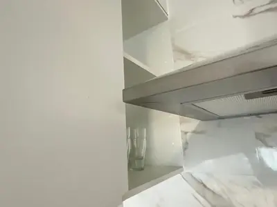 a room with white walls and a marble shelf at Beach apartment IV Coeur de Plage in Castelldefels