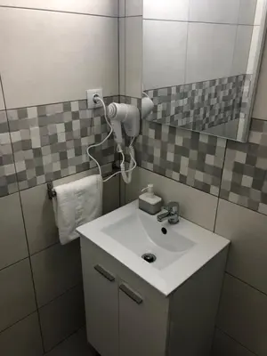 a bathroom with a white sink and a mirror at Hostal Restaurante Avenida de Madrid in Terrassa
