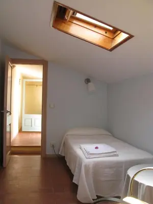 a bedroom with a bed and a skylight at Casa Le Bouganville in Sant Vicenç de Montalt