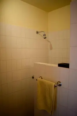 a bathroom with a shower with a towel at Casa Le Bouganville in Sant Vicenç de Montalt