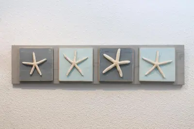 a shelf with four starfish on a wall at Hostal Portofino in Arenys de Mar