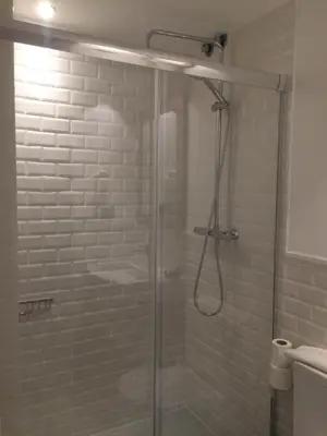a shower with a glass door in a bathroom at Hostal Portofino in Arenys de Mar