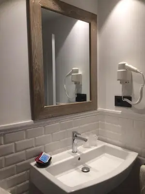 a bathroom with a sink and a mirror at Hostal Portofino in Arenys de Mar