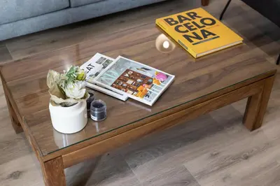 a coffee table with a sign on top of it at LucasLand Apartments Barcelona in Barcelona