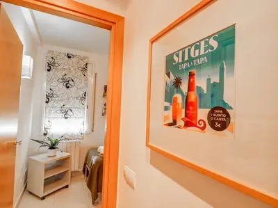 a hallway with a picture of bottles on the wall at Benito Apartment by Hello Homes Sitges in Sitges