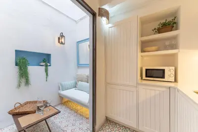 a hallway with a door leading to a living room at Casa Azul by Hello Homes Sitges in Sitges