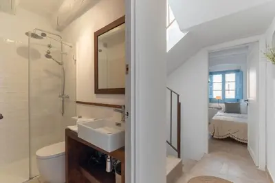 a bathroom with a sink and a toilet and a shower at Casa Azul by Hello Homes Sitges in Sitges
