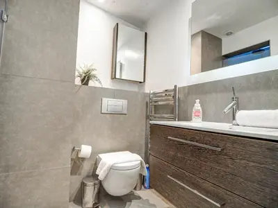 a bathroom with a toilet and a sink at Chic by Hello Homes Sitges in Sitges