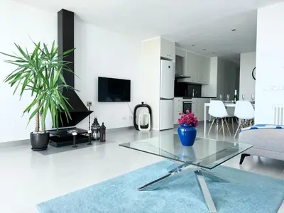 a living room with a glass table in a room at Vistas Del Mar by Hello Homes Sitges in Sitges