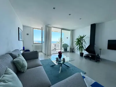 a living room with a couch and a glass table at Vistas Del Mar by Hello Homes Sitges in Sitges