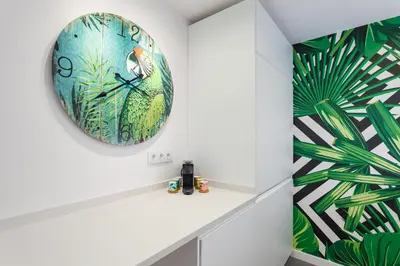 a clock hanging on a wall in a room with a wall at Art House Paral-lel Sant Antoni in Barcelona
