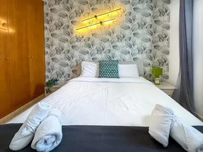 a bedroom with a large white bed with towels on it at Sunlight by Hello Homes Sitges in Sitges