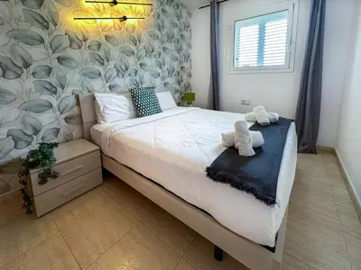 a bedroom with a bed with two stuffed animals on it at Sunlight by Hello Homes Sitges in Sitges