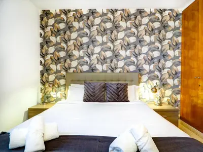 a bedroom with a bed and a wall with hats at Sunlight by Hello Homes Sitges in Sitges