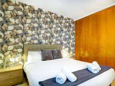 a bedroom with a bed with towels on it at Sunlight by Hello Homes Sitges in Sitges