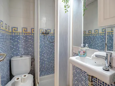 a bathroom with a toilet and a sink and a shower at Soleil by Hello Homes Sitges in Sitges