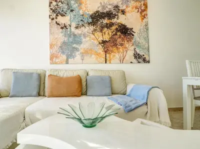 a living room with a couch and a painting on the wall at Diamond by Hello Homes Sitges in Sitges