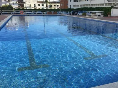 a large pool of blue water in a building at Diamond by Hello Homes Sitges in Sitges