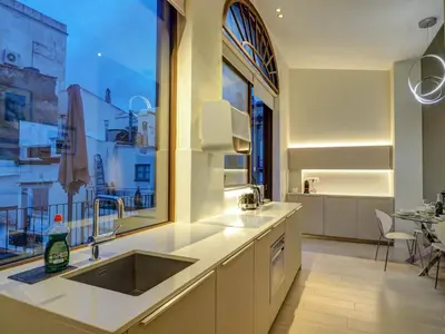 a kitchen with a sink and a large window at En Vogue by Hello Homes Sitges in Sitges