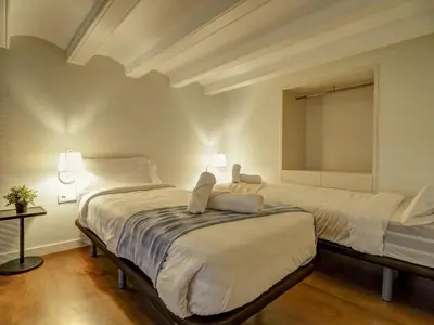a bedroom with two beds and a window at En Vogue by Hello Homes Sitges in Sitges