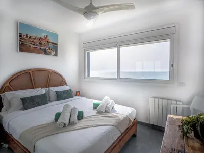 a bedroom with a bed with towels on it at Marina Duplex by Hello Homes Sitges in Sitges