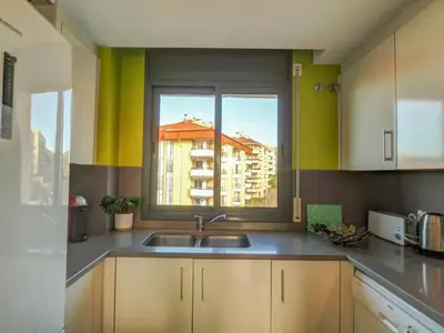 a kitchen with a sink and a window at Mimosa Apartment by Hello Homes Sitges in Sitges