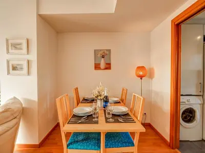 a dining room with a wooden table and chairs at Mimosa Apartment by Hello Homes Sitges in Sitges