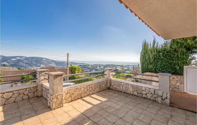 an outdoor balcony with a view of the mountains at Gorgeous Home In Sant Cebrià De Vallalt in San Cipriano de Vallalta
