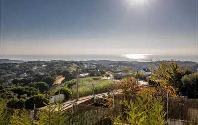 a view of a town with the ocean in the background at Gorgeous Home In Sant Cebrià De Vallalt in San Cipriano de Vallalta
