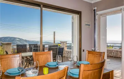 a dining room with a table and chairs and a large window at Gorgeous Home In Sant Cebrià De Vallalt in San Cipriano de Vallalta