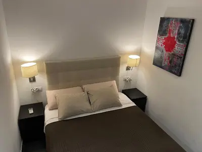a bedroom with a bed with two night stands and two lamps at GORGEOUS APARTMENT IN DOWNTOWN in Barcelona