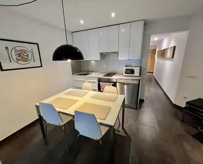 a kitchen and dining room with a table and chairs at GORGEOUS APARTMENT IN DOWNTOWN in Barcelona