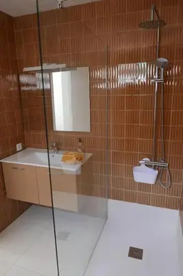a bathroom with a shower and a sink and a mirror at ALOJAMIENTO CON JARDIN 20KM BARCELONA in Vilassar de Dalt
