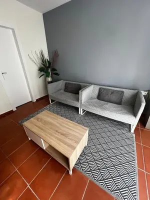 a living room with two couches and a coffee table at ALOJAMIENTO CON JARDIN 20KM BARCELONA in Vilassar de Dalt